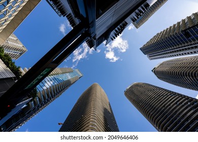 Ground angle photo looking directly up towards highrise towers in the city