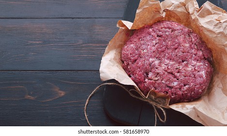 Ground Beef In A Paper Bag On The Table