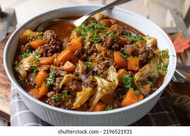 Ground beef stew with vegetables and cabbage in a bowl - Shutterstock ID 2196521931