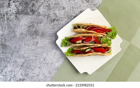 Ground Beef Tacos With Lettuce, Tomatoes, Pink Onions On A White Square  Plate On A Dark Background. Top View, Flat Lay