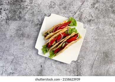 Ground Beef Tacos With Lettuce, Tomatoes, Pink Onions On A White Square  Plate On A Dark Background. Top View, Flat Lay