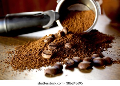 Ground coffee and beans  on wooden background