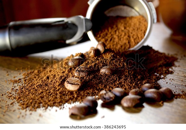 Ground coffee and\
beans  on wooden\
background