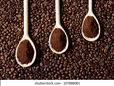 Ground Coffee On A Spoon And Coffee Beans