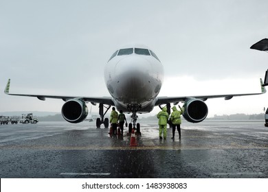 Ground Crew Checking On A Plane After Landing On Wet Runway At Adisucipto Airport Yogyakarta Indonesia On December 2018