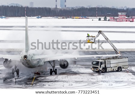 Ground crew provides de icing. They are spraying the aircraft, which prevents the occurrence of frost