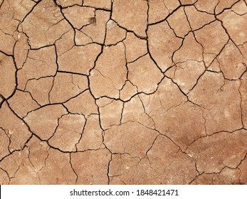 The ground has cracks in the top view for the background or graphic design with the concept of drought and death. - Shutterstock ID 1848421471