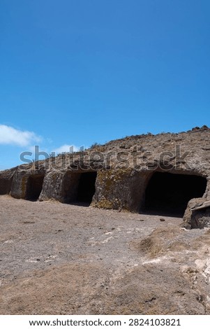 Ground level perspective of ancient Guanche archaeological cave dwellings hand carved in volcanic tufa stone.