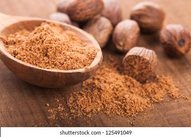 Ground Nutmeg Spice In The Wooden Spoon Closeup