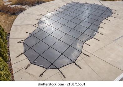 in the ground pool has been winterized with a pool cover - Shutterstock ID 2138715531