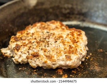 A Ground Pork Breakfast Sausage Being Cooked In A Cast Iron Skillet. 