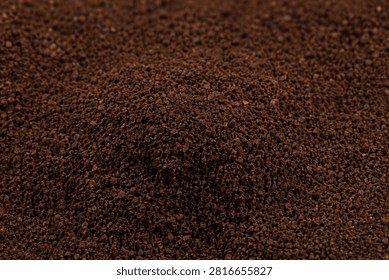 Ground Roasted Espresso Beans Texture. A gritty heap of dark brown invigorative powder. Symbolizes energy, morning rituals, and cozy warmth from artisanal home brewing.