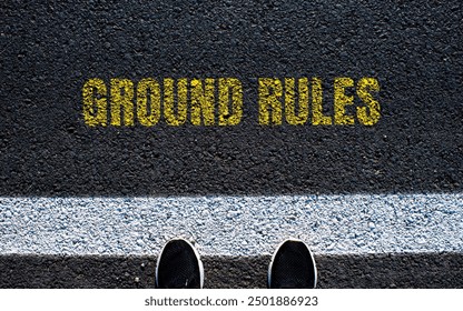Ground rules message written on asphalt road. Conceptual ground rules symbol. Copy space.