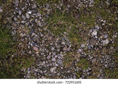 A Ground Texture Background With Pieces Of Grass, Small Rocks/pebbles And Dirt Photographed From Above