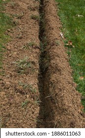 Ground Trench For A Drain Pipe In Tall Fescue Lawn Dug With A Trench Digger