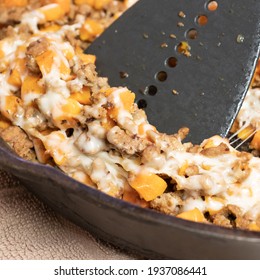 Ground Turkey Meat, Cubed Sweet Potatoes, Melted Mozzarella Cheese, And Diced Onions Served For Dinner In A Cheesy, Nutritious Cast Iron Skillet Meal In A Home Kitchen.