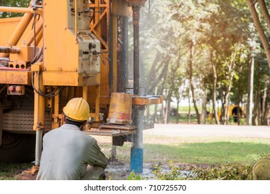Ground water hole drilling machine installed on the old truck in Thailand. Worker keeping an eye on Ground water well drilling. Ground water well drilling.