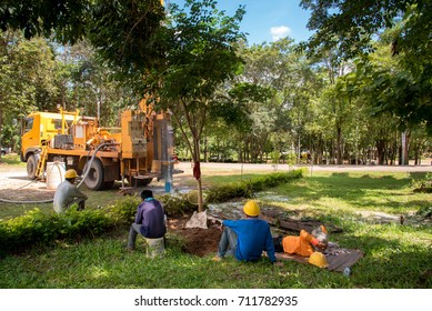 Ground Water Hole Drilling Machine Installed On The Old Truck In Thailand. Worker Waiting And Keeping An Eye On Ground Water Well Drilling.