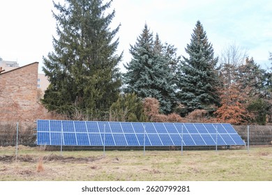Ground-Mounted Solar Panel Array in Front Yard of Residential Home with Evergreen Trees