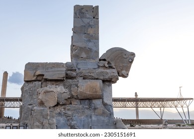 The grounds of Persepolis, Achaemenid soldiers carved on the rock, the lion and bull battle, the throne of Xerxes, tourists visiting Persepolis at sunset