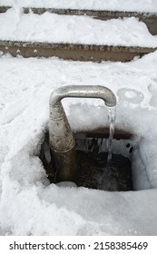 The Groundwater Flowing From A Frozen Outdoor Water Tap