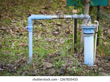 Groundwater Well With Pvc Pipe And System Electric Deep Well Submersible Pump Water On Green Meadow / Groundwater Testing And Sampling Pollution Concept