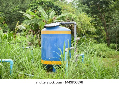 Groundwater Well With Pvc Pipe And System Electric Deep Well Submersible Pump Water Tank On Green Meadow / Groundwater Testing And Sampling Pollution Concept