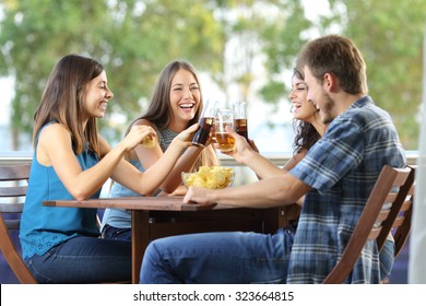 Group of 4 happy friends toasting in an hotel or home terrace - Powered by Shutterstock