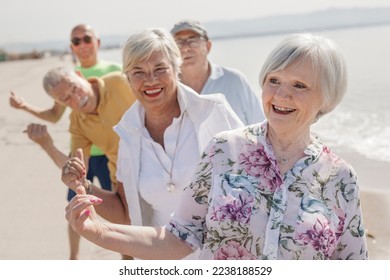 group of 5 seniors at the sea play happily making the "ok" sign with their finger - Shutterstock ID 2238188529