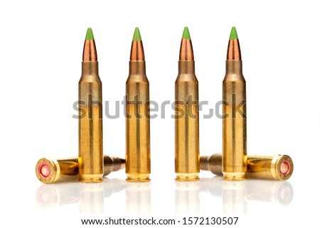 A group of 5.56 calibar, green tip bullets on white background