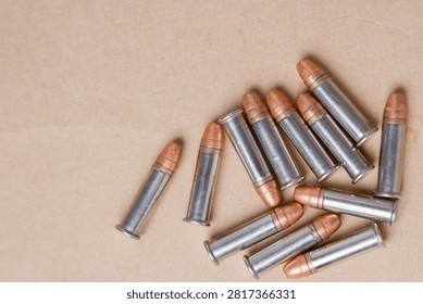 Group of 7.62 mm bullets on brown paper background with copy space