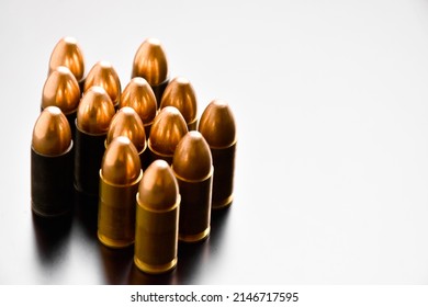 Group of 9mm pistol bullets on gray background, soft and selective focus.