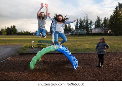 Group Of Active Children Jumping And Playing Outside At School P