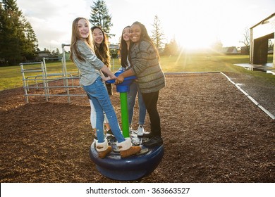 Group Of Active Children Playing Outside At School Playground