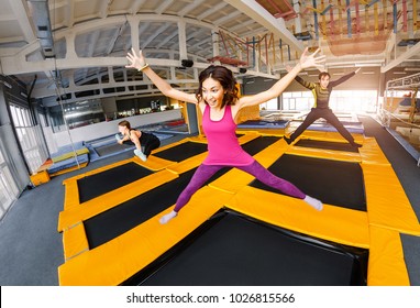A group of active friends jumping and bouncing on a trampoline, the concept of a youth fitness center