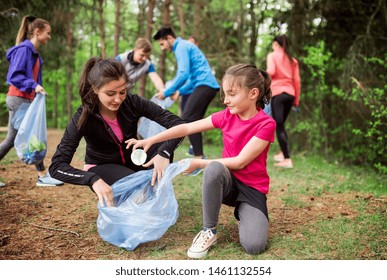 Group of active people picking up litter in nature, a plogging concept. - Powered by Shutterstock