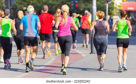 Group Of Active People Running In The City. Healthy Lifestyle. Weight Loss. Urban Marathon Run.