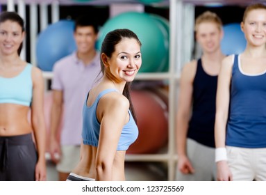 Group Of Active People In Sportswear At The Gym In A Aerobics Class