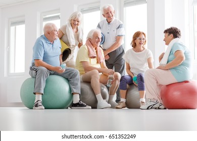 Group Of Active Senior People Talking After Training