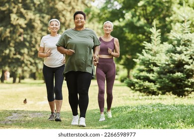 Group of active senior women running towards camera outdoors and smiling - Powered by Shutterstock