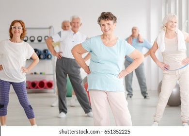 Group Of Active Seniors Exercising In Fitness Club