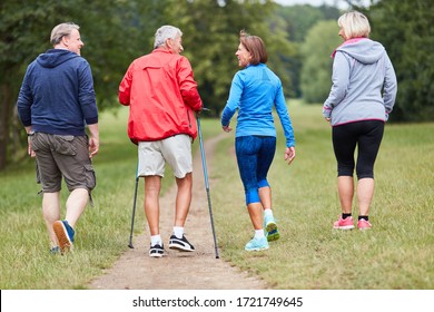 Group Of Active Seniors As Friends Do Nordic Walking In Nature