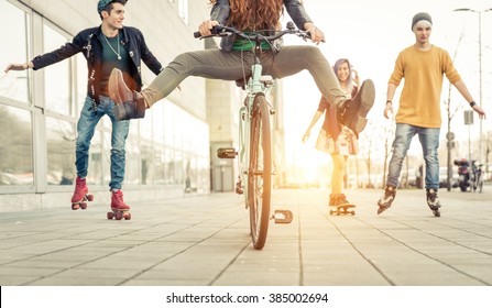 Group Of Active Teenagers In Town. Four Teens Making Recreational Activity In An Urban Area