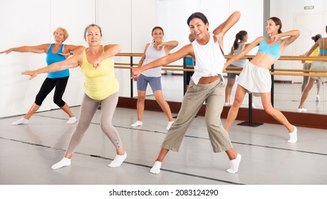 Group Of Active Women Practicing Energetic Dance In A Modern Dance Studio