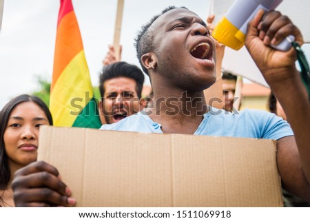 Group of activists is protesting outdoors - Crowd demonstrating against unemployment, taxes, wages dumping and other political and social issues, white signboards for any concepts