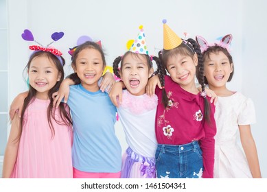 Group Of Adorable Asian Girls Having Fun At Birthday Party

