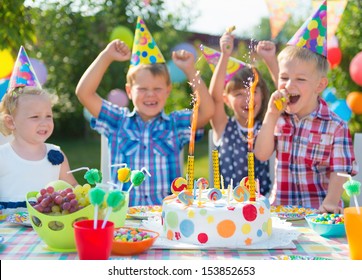 Group Of Adorable Kids Having Fun At Birthday Party 