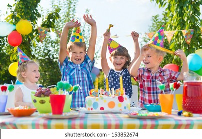 Group Of Adorable Kids Having Fun At Birthday Party 