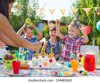 Group Of Adorable Kids Having Fun At Birthday Party 