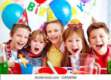 Group of adorable kids looking at camera at birthday party